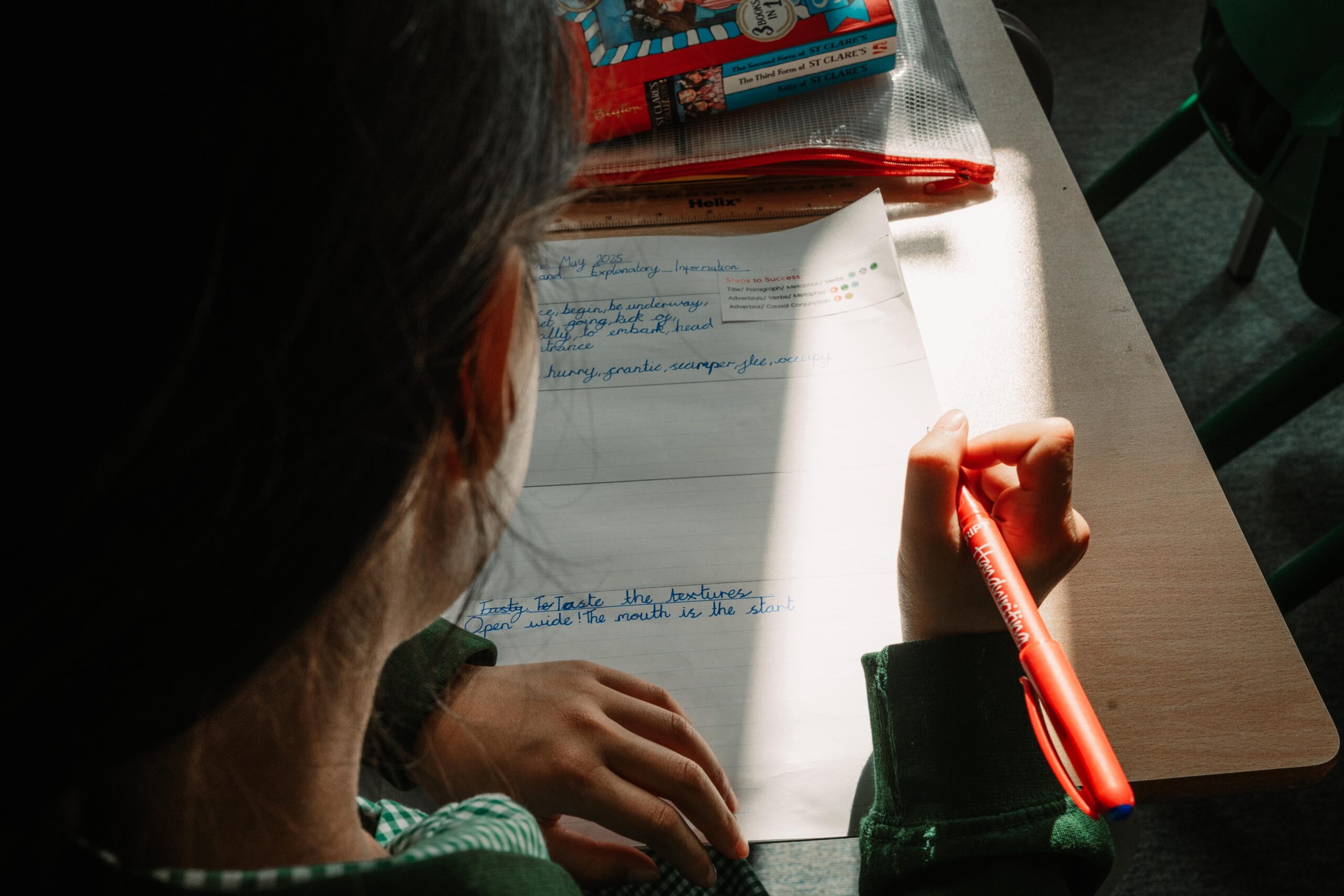 a pupil writing in their text book